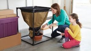Urban Worm Bag with mom showing daughter how compost comes from the bottom